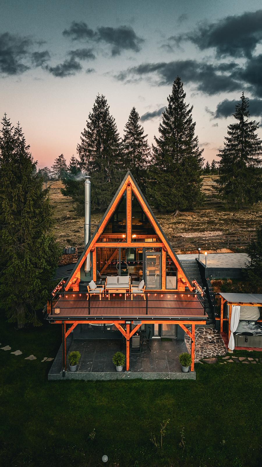 Cabin exterior at sunset with mountain view