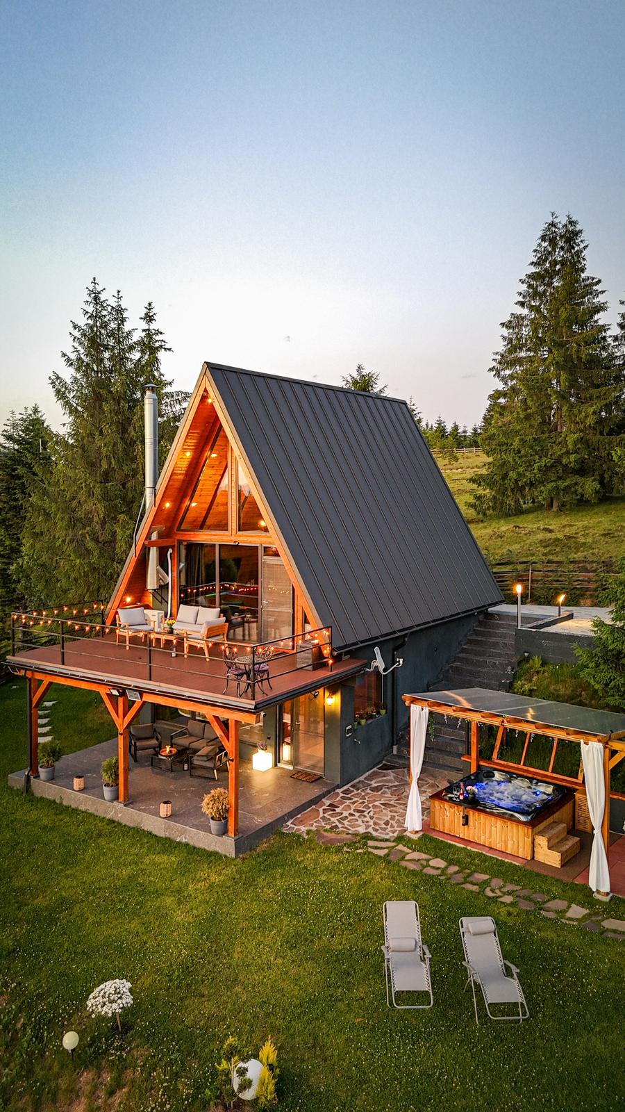 Cabin aerial view at dusk with hot tub area
